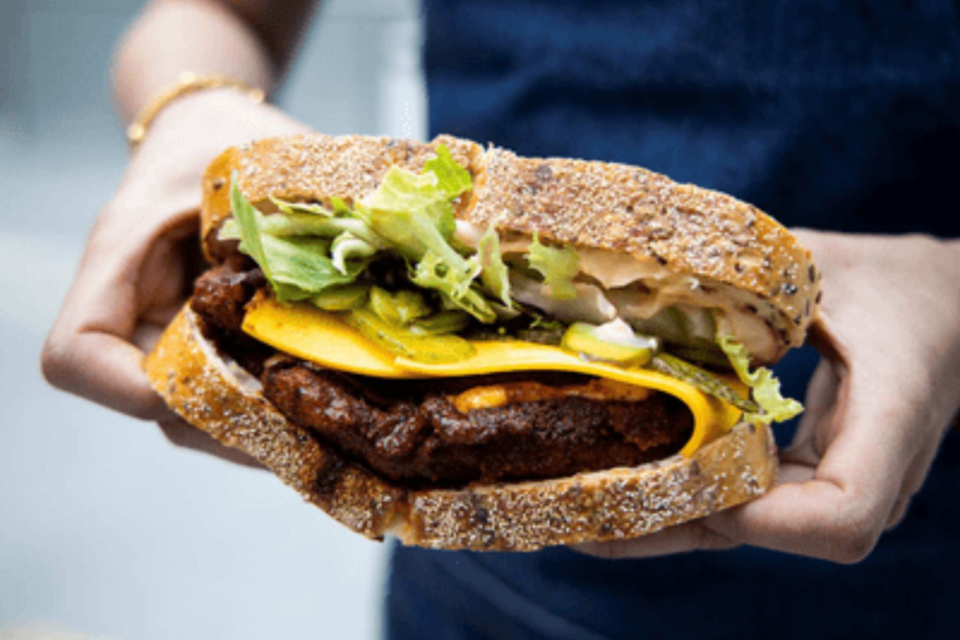 A North Sandwiches burger held in both hands